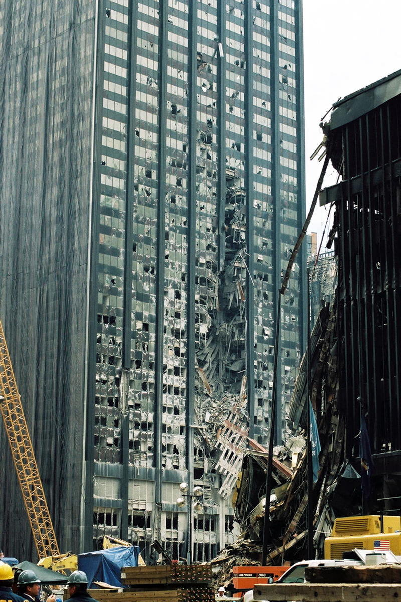 Bankers Trust building showing large circular gash with prefabricated perimeter column assembly hanging suspended, demonstrating impedance mismatch